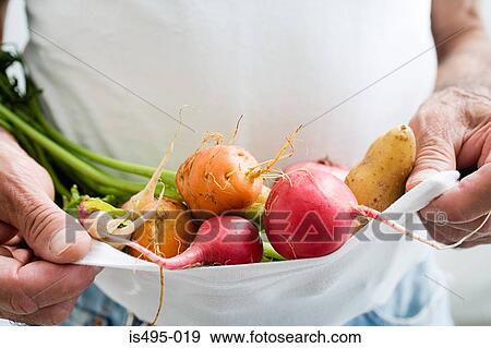 Man carrying vegetables in a t shirt View Large Photo Image Stock Photo - Man carrying vegetables in a t shirt. Fotosearch