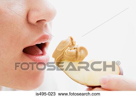 Woman eating apple and peanut butter View Large Photo Image Stock Image - Woman eating apple and peanut butter. Fotosearch