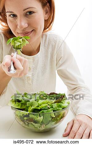 Woman eating lettuce View Large Photo Image Stock Image - Woman eating lettuce. Fotosearch