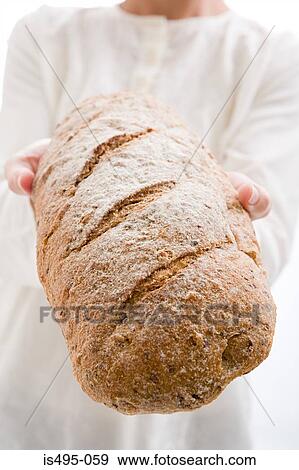 Woman holding loaf of bread View Large Photo Image Stock Photo - Woman holding loaf of bread. Fotosearch