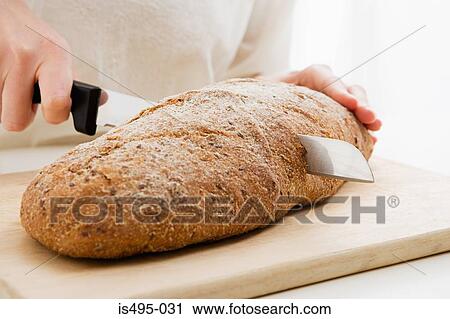 Woman slicing loaf View Large Photo Image Stock Image - Woman slicing loaf. Fotosearch