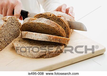 Woman slicing loaf View Large Photo Image Stock Photo - Woman slicing loaf. Fotosearch