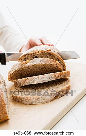 Woman slicing loaf View Large Photo Image Stock Photo - Woman slicing loaf. Fotosearch