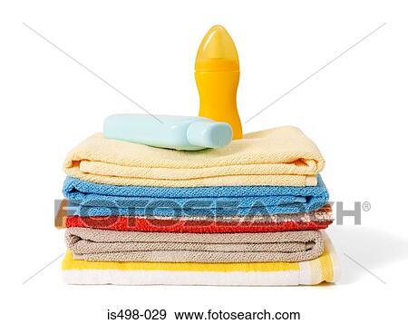 Stock Photo - Suntan lotion and beach towels. Fotosearch
