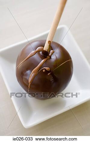 A chocolate covered apple View Large Photo Image Stock Image - A chocolate covered apple. Fotosearch