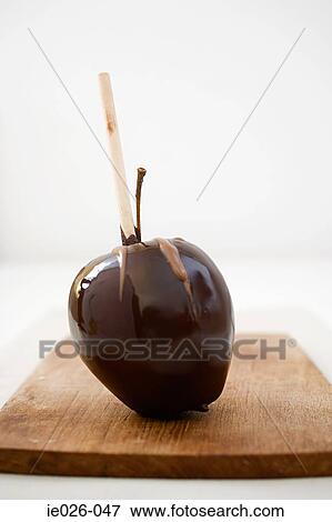 A chocolate covered apple View Large Photo Image Stock Photo - A chocolate covered apple. Fotosearch