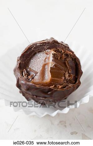 A chocolate with a missing bite View Large Photo Image Stock Photography - A chocolate with a missing bite. Fotosearch