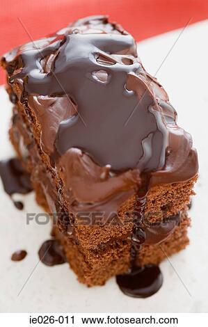 Chocolate sauce covering a cake View Large Photo Image Stock Image - Chocolate sauce covering a cake. Fotosearch