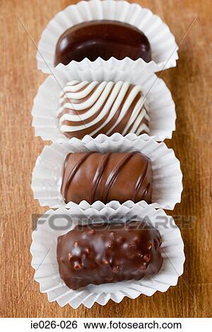 Chocolates in a row View Large Photo Image Stock Photograph - Chocolates in a row. Fotosearch