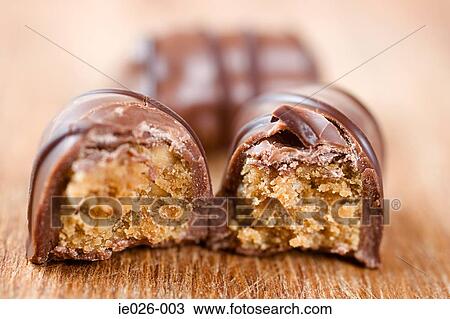 Chocolates with a missing bite View Large Photo Image Stock Image - Chocolates with a missing bite. Fotosearch