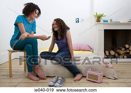 Friends using a cell phone View Large Photo Image Stock Photo - Friends using a cell phone. Fotosearch
