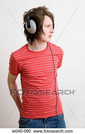 Teenage boy listening to music View Large Photo Image Stock Image - Teenage boy listening to music. Fotosearch