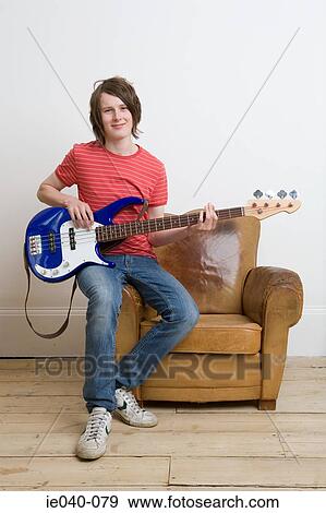 Stock Photo - Teenage boy playing guitar. Fotosearch