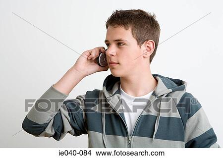 Teenage boy using cell phone View Large Photo Image Picture - Teenage boy using cell phone. Fotosearch