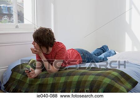 Teenage boy using cell phone View Large Photo Image Stock Photo - Teenage boy using cell phone. Fotosearch