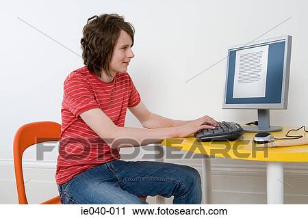 Teenage boy using personal computer View Large Photo Image Stock Image - Teenage boy using personal computer. Fotosearch