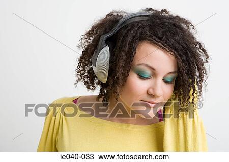 Stock Image - Teenage girl listening to music. Fotosearch