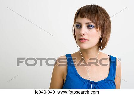 Stock Image - Teenage girl listening to music. Fotosearch