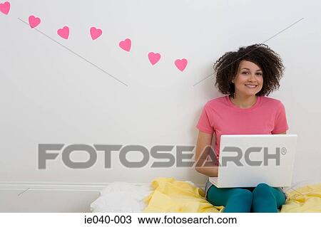 Teenage girl using laptop View Large Photo Image Stock Image - Teenage girl using laptop. Fotosearch
