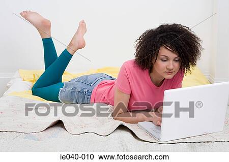 Teenage girl using laptop View Large Photo Image Stock Image - Teenage girl using laptop. Fotosearch