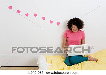 Stock Photography - Teenage girl using laptop. Fotosearch