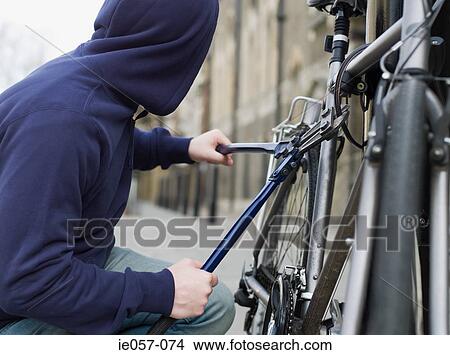 A thief stealing a bike View Large Photo Image Picture - A thief stealing a bike. Fotosearch