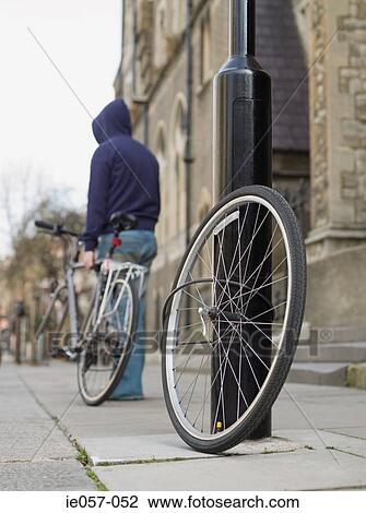 Stock Image - A thief stealing a bike. Fotosearch