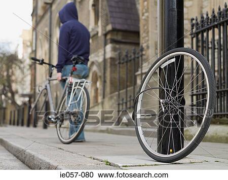 A thief stealing a bike View Large Photo Image Stock Image - A thief stealing a bike. Fotosearch