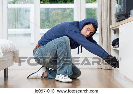 Burglar looking through cupboard View Large Photo Image Stock Image - Burglar looking through cupboard. Fotosearch