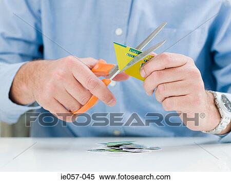 Man cutting up credit card View Large Photo Image Stock Photography - Man cutting up credit card. Fotosearch