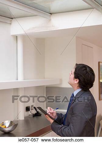 Stock Photo - Surveyor writing on clipboard. Fotosearch
