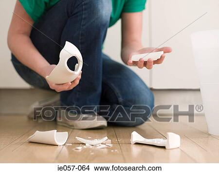 Woman holding a broken vase View Large Photo Image Picture - Woman holding a broken vase. Fotosearch