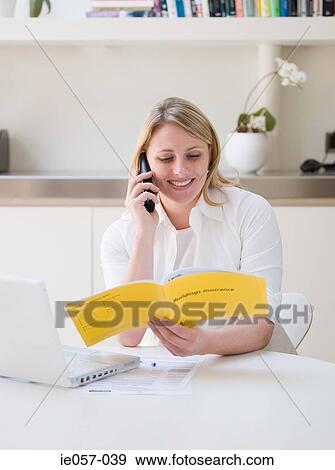 Woman making an insurance claim on the phone View Large Photo Image Stock Photo - Woman making an insurance claim on the phone. Fotosearch