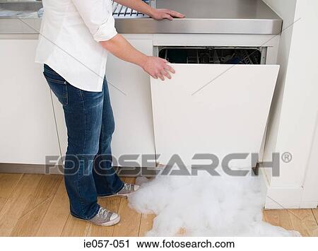 Woman opening a leaking dishwasher View Large Photo Image Stock Image - Woman opening a leaking dishwasher. Fotosearch