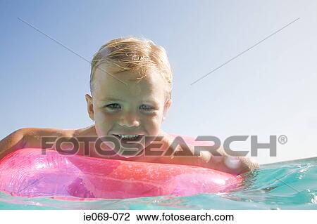 Stock Image - Boy in a swimming pool. Fotosearch
