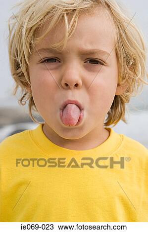 Boy sticking out tongue View Large Photo Image Stock Image - Boy sticking out tongue. Fotosearch