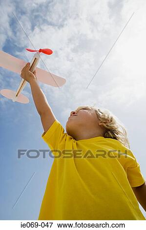 Boy with toy aeroplane View Large Photo Image Stock Photo - Boy with toy aeroplane. Fotosearch
