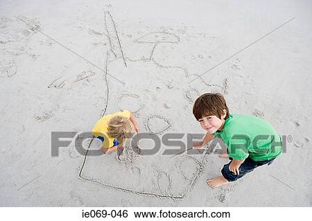 Stock Photograph - Boys drawing in sand. Fotosearch