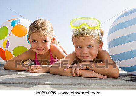 Stock Photograph - Girl and boy on holiday. Fotosearch