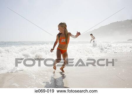 Girl playing by the sea View Large Photo Image Stock Photo - Girl playing by the sea. Fotosearch
