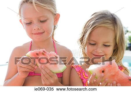 Stock Photography - Girls with watermelon slices. Fotosearch