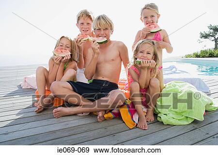 Stock Photo - Kids eating watermelon. Fotosearch