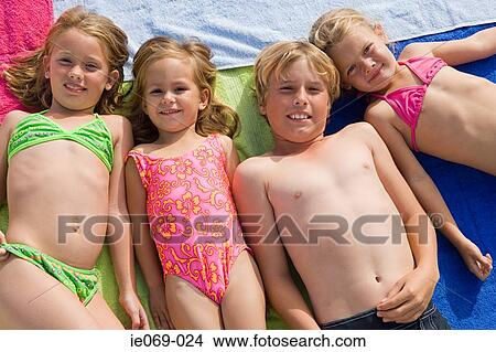 Kids lying on towels View Large Photo Image Picture - Kids lying on towels. Fotosearch