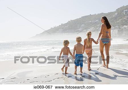 Stock Photo - Mother and children on a beach. Fotosearch