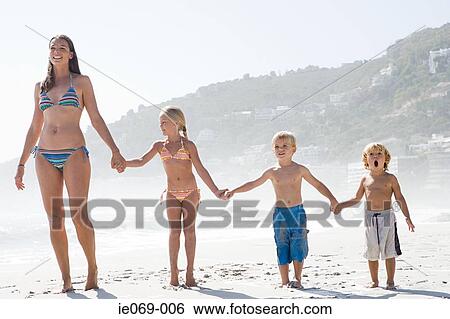 Mother and children on a beach View Large Photo Image Stock Photograph - Mother and children on a beach. Fotosearch