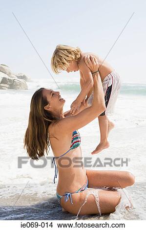 Mother and son in the sea View Large Photo Image Picture - Mother and son in the sea. Fotosearch