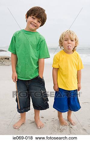 Two boys on a beach View Large Photo Image Stock Photo - Two boys on a beach. Fotosearch