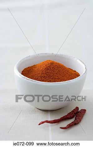 Stock Photo - Bowl of chilli powder and chilli peppers.... Fotosearch