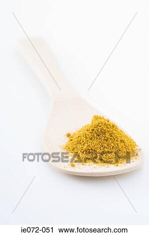 Curry powder and a wooden spoon View Large Photo Image Stock Image - Curry powder and a wooden spoon . Fotosearch