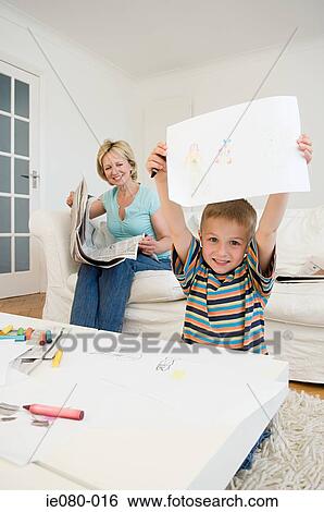 Stock Photograph - Boy holding a drawing. Fotosearch